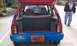 1991 Ford Festiva - Rear view of a 1991 Ford Festiva showing its interior and open trunk, with a man in the background.