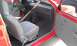 1991 Ford Festiva - The interior of a red car is shown, gray seats and door panels.