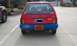 1991 Ford Festiva - Rear view of a red 1991 Ford Festiva, showing its distinctive blue bumper and Oklahoma license plate.