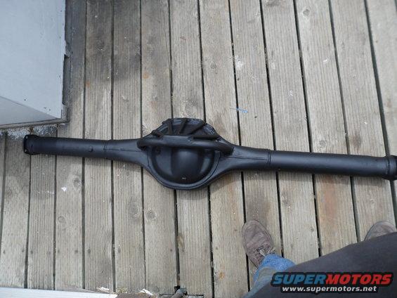 Black rear axle assembly on wooden planks