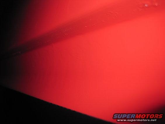 Red metal panel with dark stripe and Supermotors logo