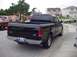 2001 Ford F-150 - Rear view of a black 2001 Ford F-150 pickup truck parked curbside on a street.