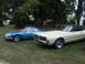 1977 Pontiac Trans Am - Two vintage cars, a blue Alpine and a cream Mercury, are parked on a grassy lawn under trees.