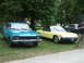 1977 Pontiac Trans Am - A yellow convertible sports car is parked next to a blue sedan and a dark sedan under trees.