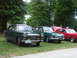 1977 Pontiac Trans Am - A lineup of vintage cars includes a green Peugeot 504 sedan with a 1977 license plate.