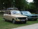 1977 Pontiac Trans Am - Two classic cars, a Renault 16 and a Ford Mustang, are parked on a grassy area with trees in the background.
