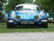 1977 Pontiac Trans Am - A blue Alpine A110 is parked on grass with trees in the background.