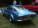 1977 Pontiac Trans Am - Blue Alpine-Renault coupe parked on grass with a red car in the background.