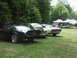 1977 Pontiac Trans Am - A black 1977 Pontiac Trans Am is parked in a grassy field next to other vehicles.