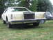 1977 Pontiac Trans Am - A Lincoln Continental Mark V is parked on a grassy lawn, with another vehicle visible in the background.