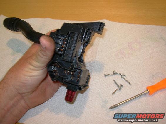 02screws.jpg Hold the case together firmly as the screws are removed.  The springs are near the hazard button, so take those screws out last.  Push the lever forward to the Hi-Beam position, and turn the hazards OFF (not like this pic).