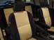 2010 Toyota FJ Cruiser - The interior of a vehicle features two-tone seats with beige and black upholstery, visible armrests, and a center console.