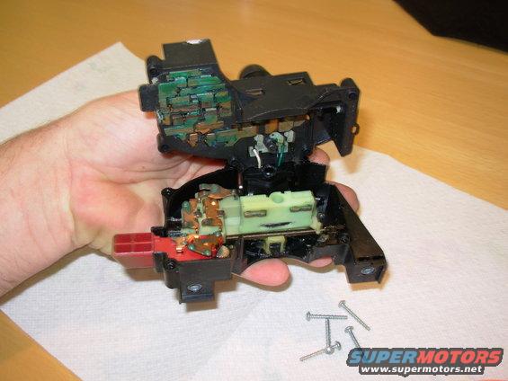 03open.jpg The parts will be loose as soon as the case separates, so hold it this way.  Sliding the top slightly toward center will disengage the beam select slider (unlike this pic where that slider stayed on the lever), making it easier to split the case.