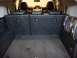 2010 Toyota FJ Cruiser - The cargo area of a 2010 Toyota FJ Cruiser is shown, with the rear seats folded down and a speaker visible on the right side.