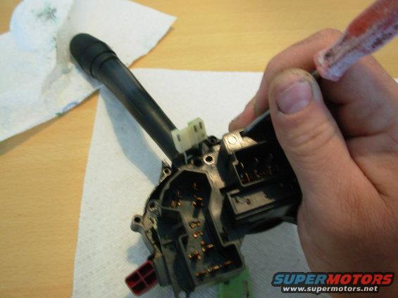 08wiperconn.jpg While splitting the case, release the catch on the wiper connector using a fine flat screwdriver or probe through this access hole.  It will still take some force to pull the front case up off the connector, and the lever MUST be held down against the rear case half.