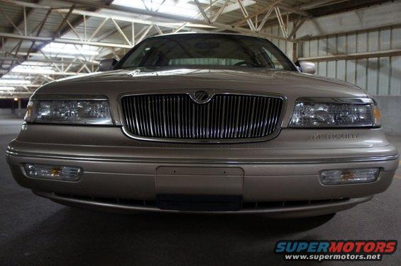 Front view of a tan 2000 Mercury Grand Marquis parked indoors