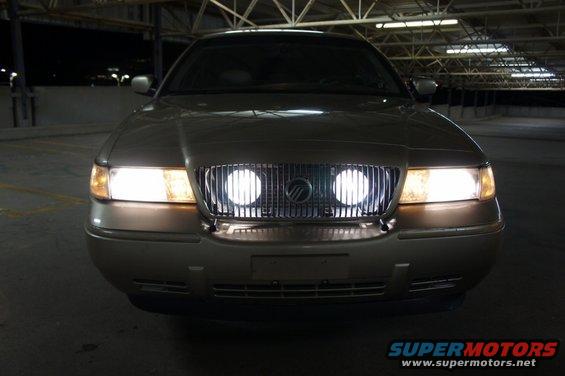 Gold Mercury Grand Marquis front view with headlights on