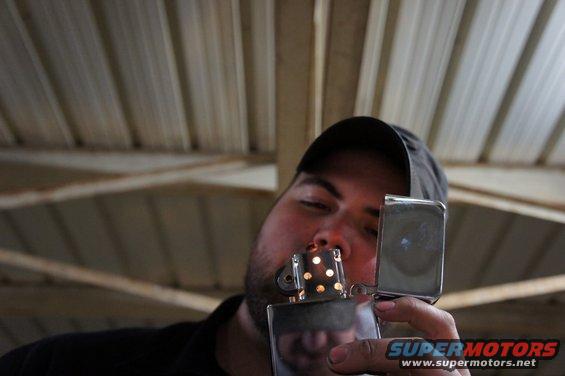 Man lighting a Zippo lighter