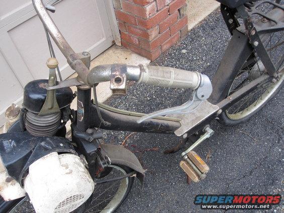 Black moped handlebars, engine, and pedals
