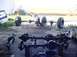 1992 Ford Bronco - Several vehicle axles and large tires are laid out on the ground, suggesting a repair or modification process.