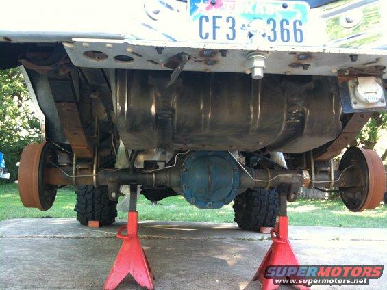 Rear axle, fuel tank, and leaf springs of a vehicle on jack stands