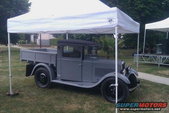 Gray pickup truck parked under a white tent