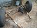 1994 Ford Explorer - A vehicle's front axle assembly, complete with tires and suspension parts, rests on the ground.