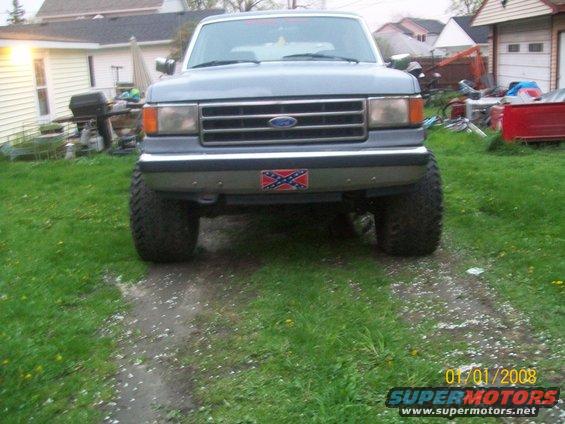 Front view of a lifted Ford F-Series truck with a Confederate flag sticker on the bumper
