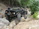 1967 Ford Mustang - Ford Bronco tackling a challenging rocky obstacle during an off-road excursion.