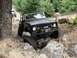 1967 Ford Mustang - A modified Ford Bronco tackles a challenging rocky terrain on an off-road trail.