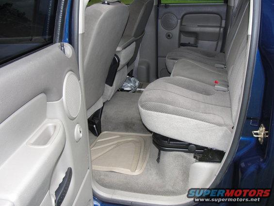 Interior of a blue pickup truck showing gray cloth seats and door panel