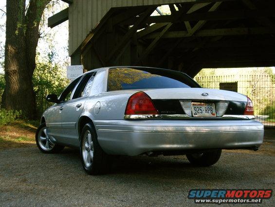 Silver sedan rear view with aftermarket wheels and custom black trim