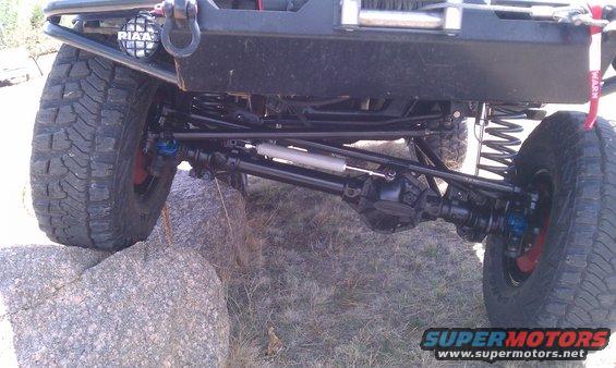 Off-road vehicle front suspension with large tires, winch, and aftermarket bumper