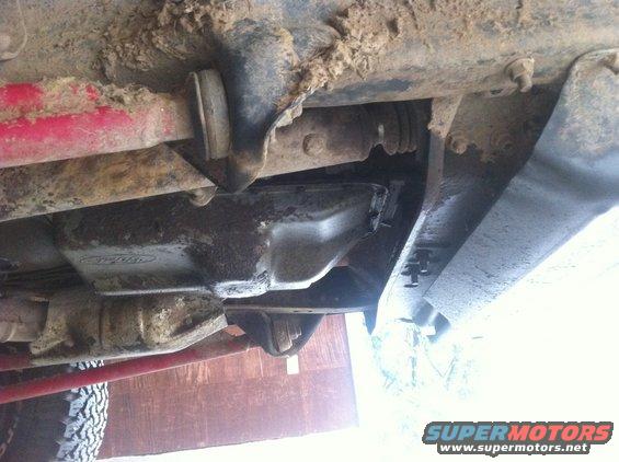 Underside view of a 1990 Ford Bronco showing the oil pan and suspension components