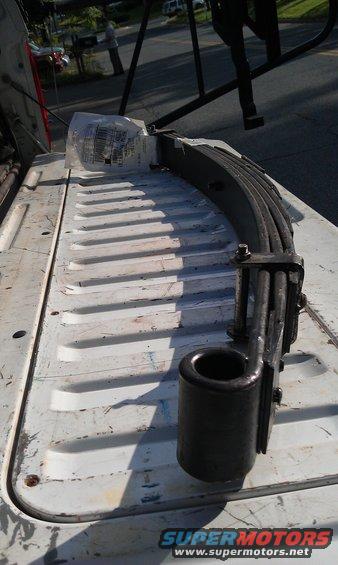 Leaf spring assembly with rubber bushing in a truck bed