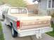 1985 Ford F-250 - Rear view of a two-tone Ford pickup truck, with a second vehicle partially visible behind it.