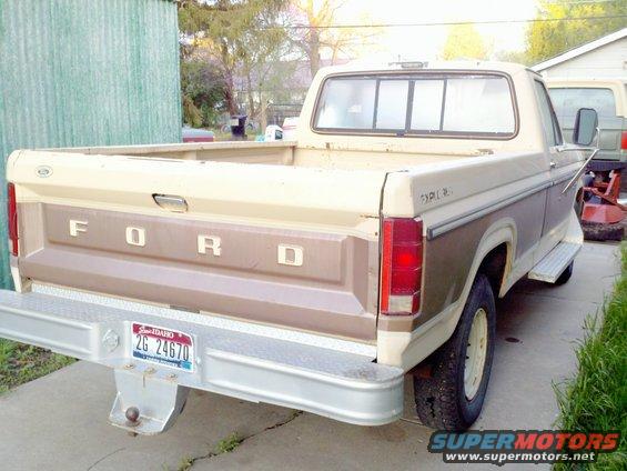 Rear view of a 1985 Ford F-250 pickup truck in tan and brown