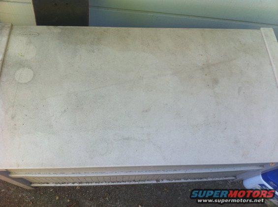 tan plastic storage container with some dirt marks