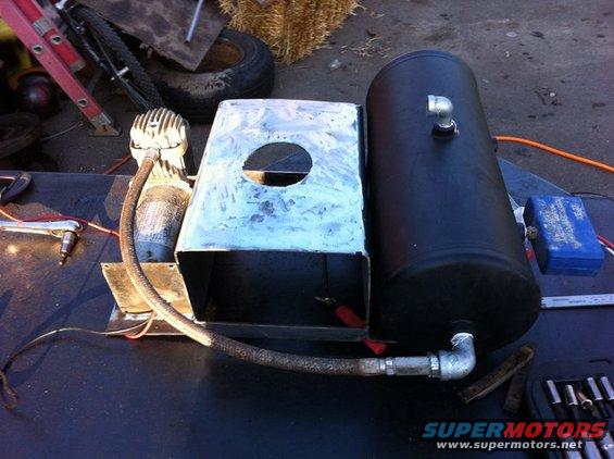 Air compressor and black tank assembly with metal housing and hoses