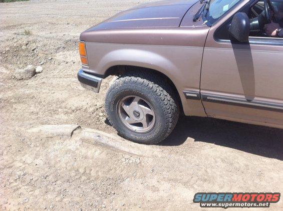 1990 Ford Explorer front fender and wheel on dirt road