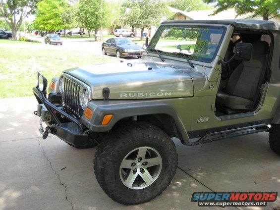 2005 Jeep Wrangler Rubicon with aftermarket bumper and winch, parked on a driveway