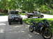 2008 Yamaha FZR1000 - A black sport motorcycle is parked on a driveway next to a Jeep and a pickup truck.