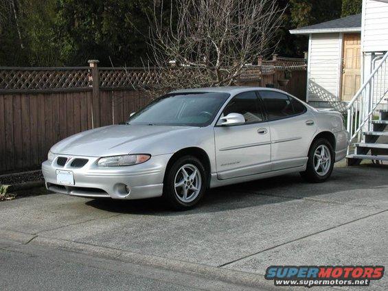 Silver 2002 Pontiac Grand Prix sedan parked in driveway