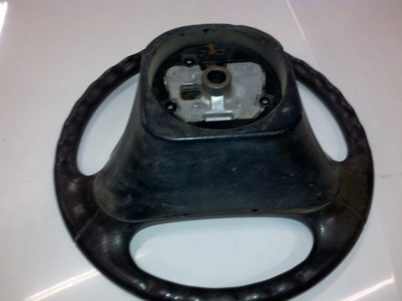 Black steering wheel, center hub visible