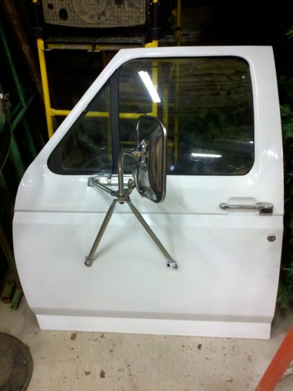White Ford truck door with chrome mirror and handle