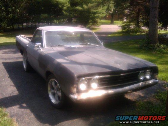 1969 Ford Ranchero primer gray, front 3/4 view, parked on driveway
