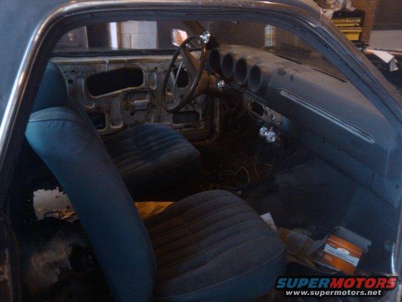 Interior of a 1969 Ford Ranchero showing blue seats and dashboard with three circular vents