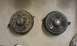 1991 Ford Festiva - A pair of old, rusty brake drums are shown resting on a floor.