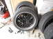 1972 Ford Bronco - A set of four tires and custom black rims with polished lips are stored indoors.