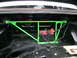 1982 BMW 3 Series - The trunk of a car shows a battery secured by a green strut bar, with a "LOCK" sticker visible on the rear window.